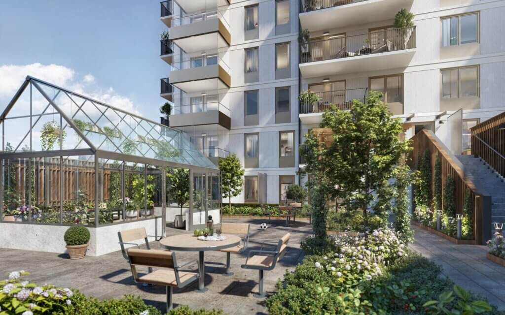 Bild av innergården med växthus i bostadsprojektet Terrasshusen i Norra Djurgårdsstaden. OBOS som står bakom projektet är en bostadsutvecklare i Sverige och Norge.